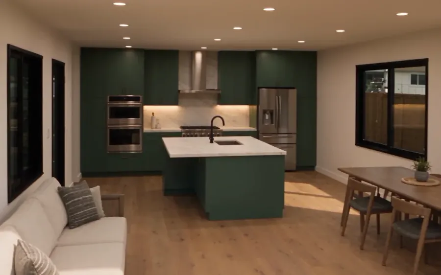 ADU interior with a kitchen island, dining table and living area under a vaulted ceiling