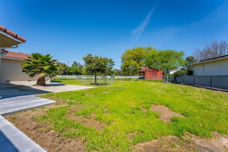 Open grass side yard beside the main house before grading